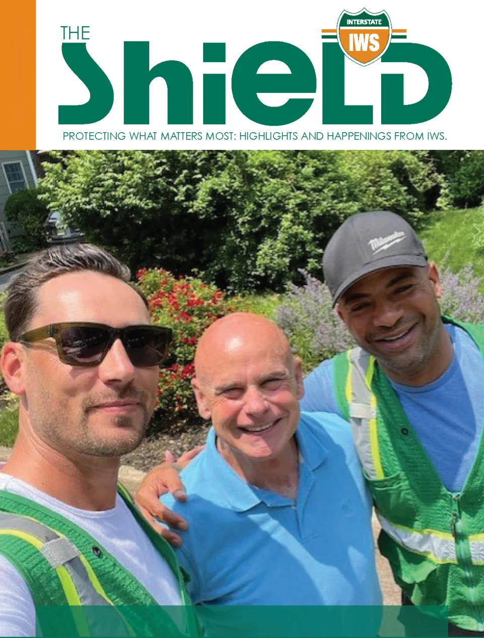 Cover of The SHIELD, the company newsletter, featuring three smiling crew members